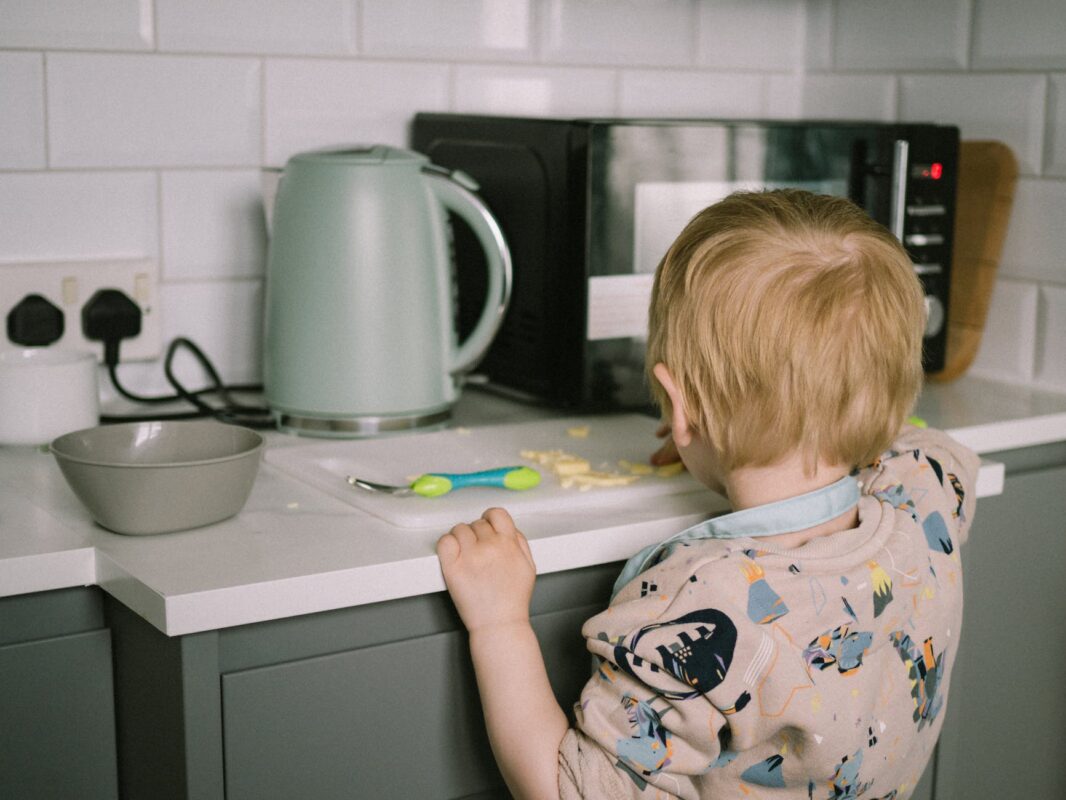 child eating food at kitchen counter